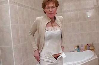 Mature lady shaving in the bathroom